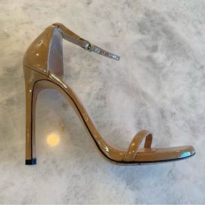“Nudist” High-heeled patent leather sandal by Stuart Weitman